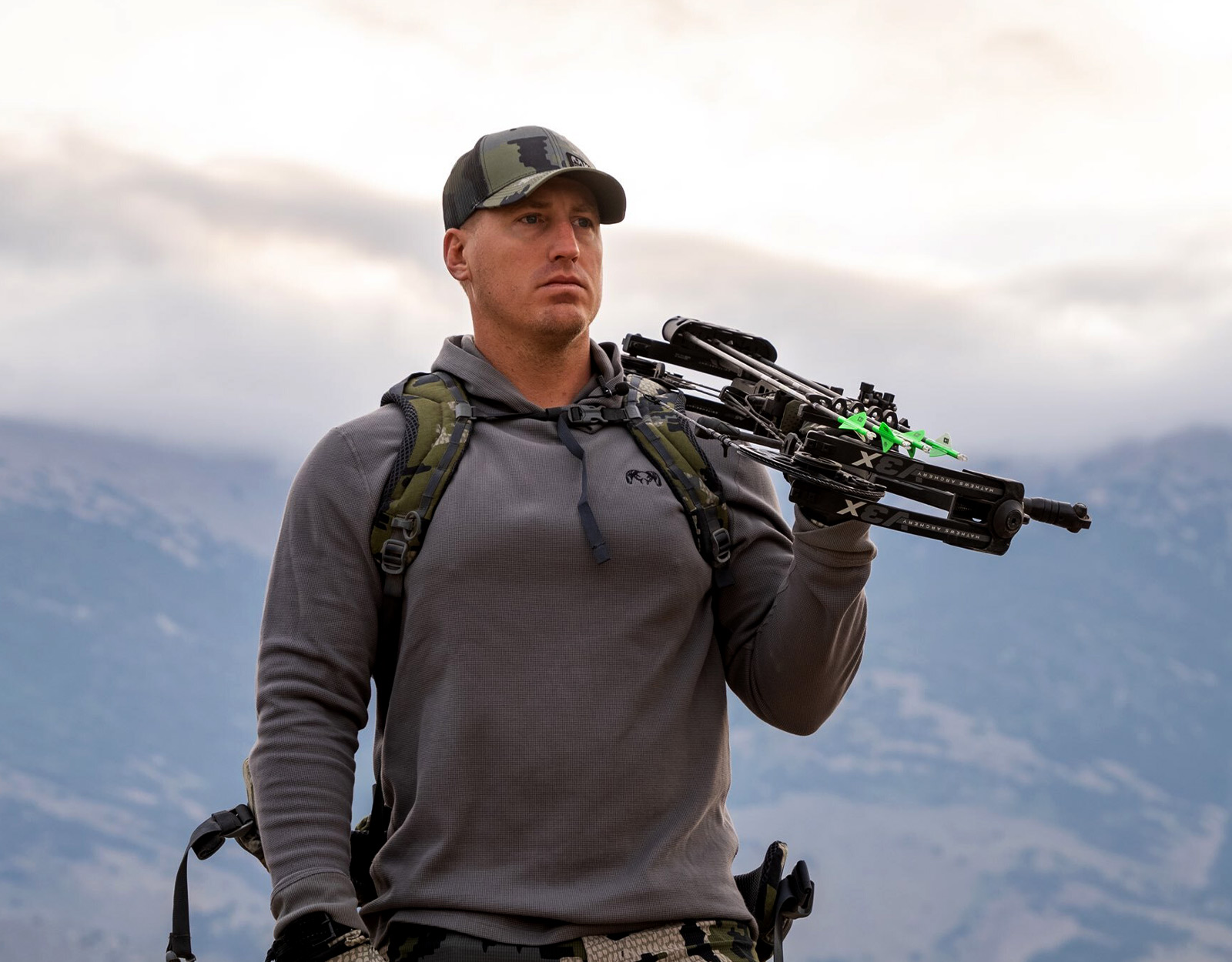 Jeff Althoff standing on a ridge with a crossbow over his shoulder.