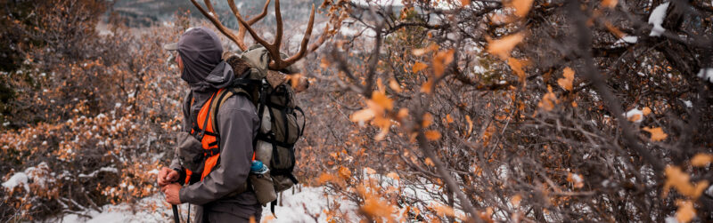 hunter with a big game hunting backpack in a snowy forrest
